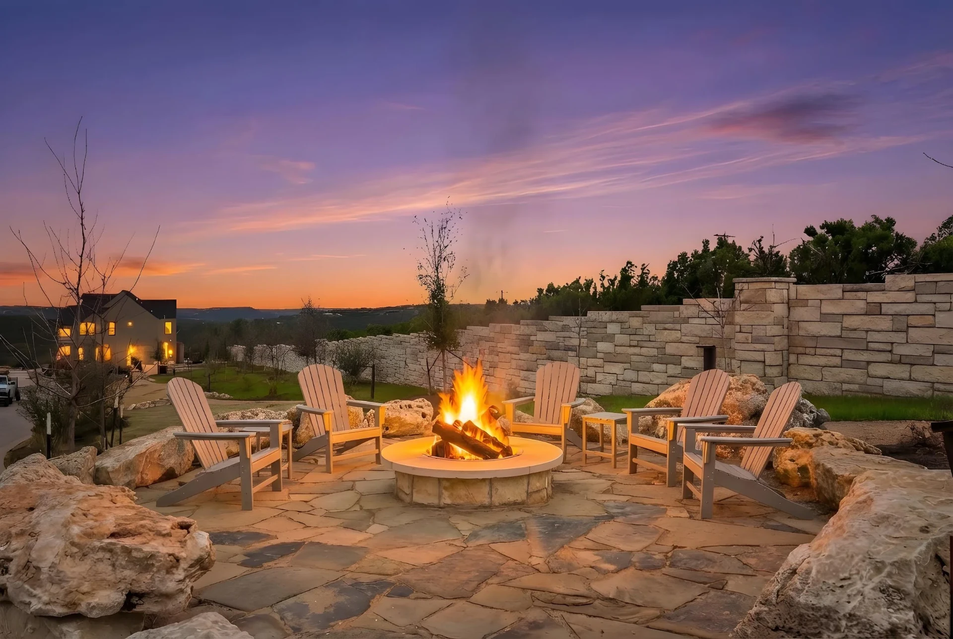 Outdoor fire pit gathering area at VUE under a hill country sunset